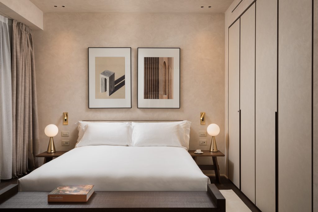 Elegant bedroom in a master Trevi Rome apartment, featuring a plush bed and stylish decor for a comfortable stay.